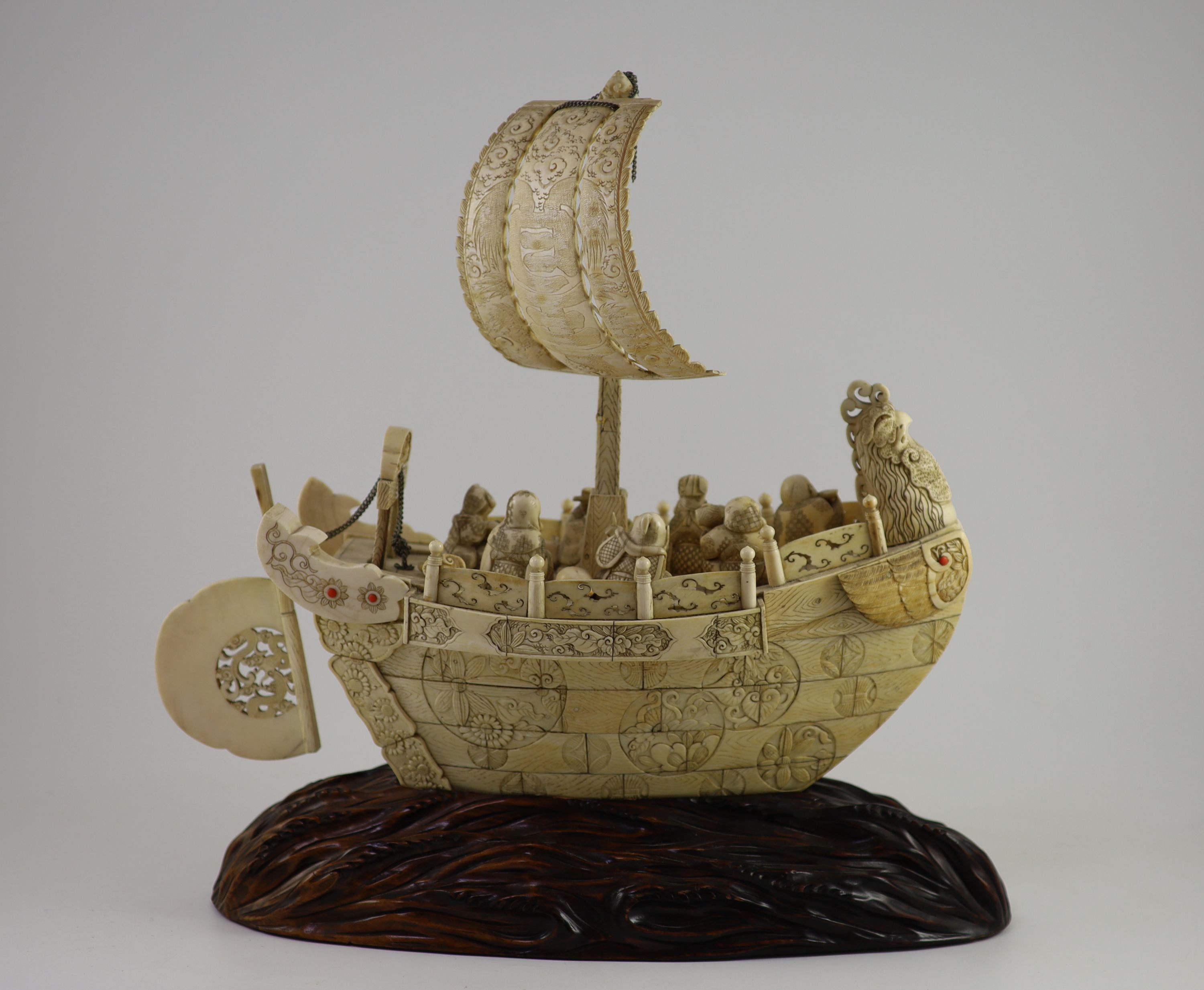 A large Japanese ivory okimono of the seven Gods of Happiness treasure ship the Takarabune, early Showa period, Total height 42 cm, length 41 cm, slight faults